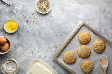 Cooking cookies, baking ingredients top view on a concrete gray background. Eggs, butter, flour,...