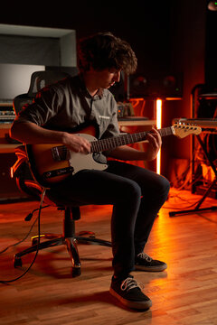 A young musician playing the guitar