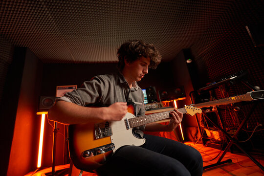 A young musician playing the guitar
