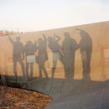 Six shadows with different poses on an old plane