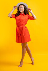 happy stylish summer woman wearing hat. stylish summer woman isolated on yellow. stylish summer woman in studio. stylish summer woman on background