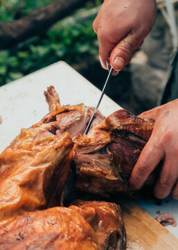 Cutting roasted homemade lamb meat
