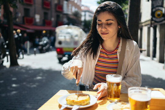Woman in Madrid eating typical spanish food