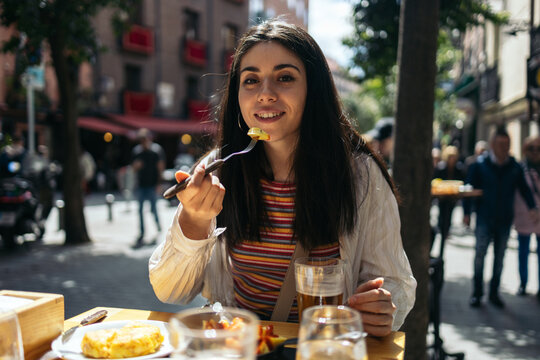 Woman eating spanish tapas and enjoying Madrid city