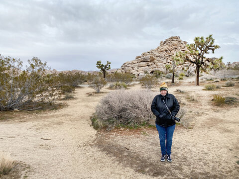 Tourist having photo taken in Joshua tree national park 