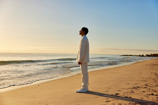 Calm man in stylish outfit on beach