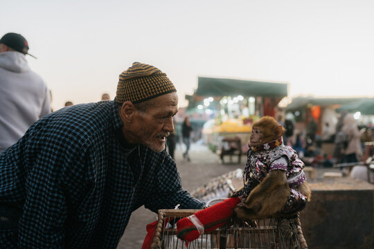 Moroccan man with monkey in a costume