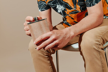 man opens or closes a hipflask