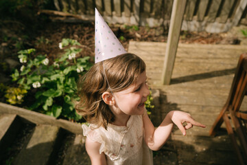 Little girl on the birthday party outdoors