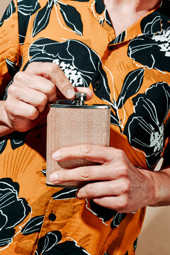 man opening or closing a hipflask