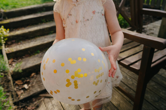 White balloon with golden decoration in hands