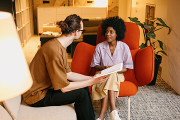 A woman communicates at a consultation in an interior design studio