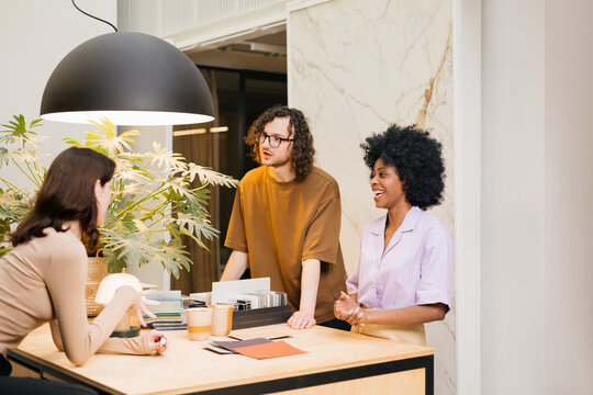 Young interior designers communicate in their office