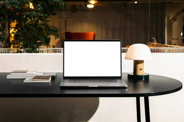 Laptop mockup on the table in the design studio