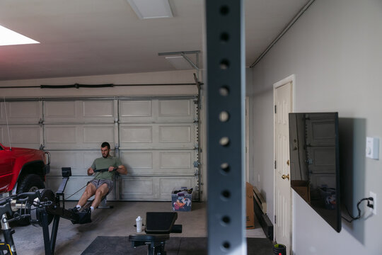 Man working out on rowing machine.