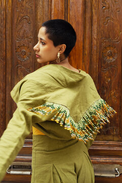 Green Elegance: A Fashionable Model on the City Streets