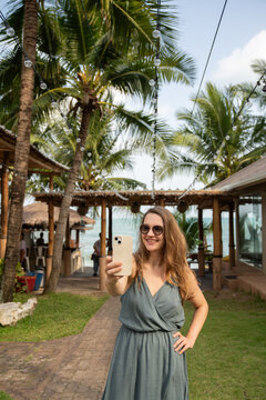 Woman Doing Selfie At Tropical Background