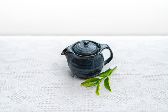 hot green tea in a cup on a white cloth background   