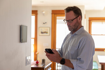 Smart Home technology Panel in Home for man in glasses  