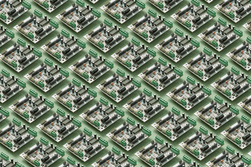 Circuit board repeated pattern on green background.