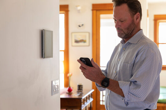 Man looks at Smart Home technology Panel in Home 