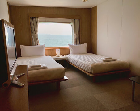 Bedroom with interior of double passenger cabin ferry ship with ocean view.