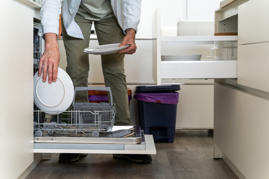 Man emptying the dishwasher