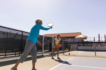 Partners match on outdoor Pickleball court  friend 