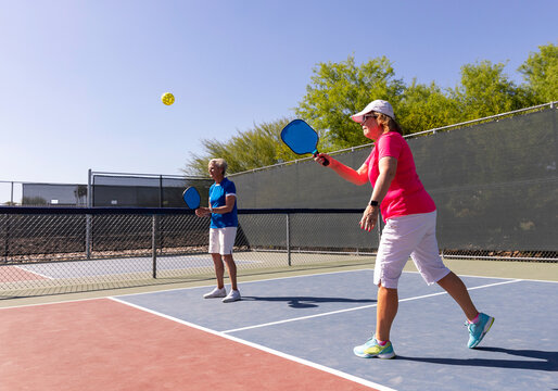 Summer pickleball match with senior women
