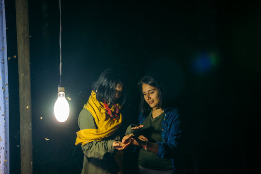 Two women doing ecotourism activities at night 