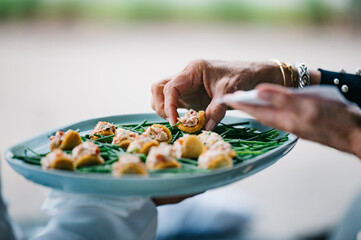Taking hors d'oeuvres from a plate