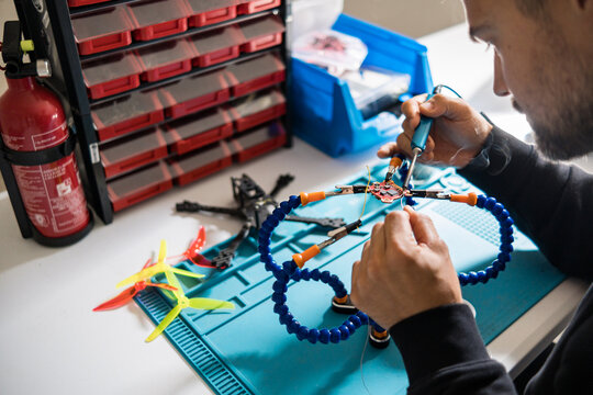 man fixing electronic component of a drone