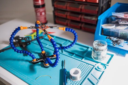 man fixing electronic component of a drone