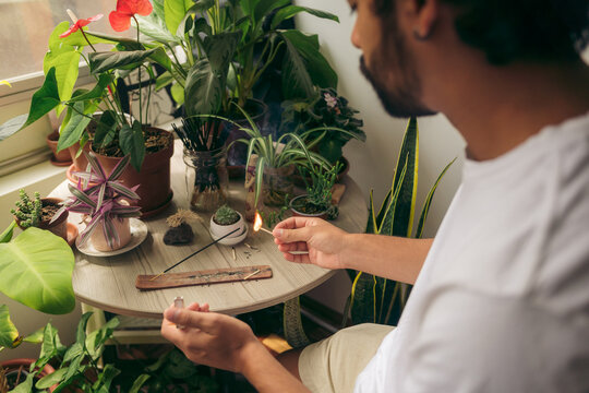 Man lighting an incense