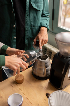 Anonymous couple preparing coffee