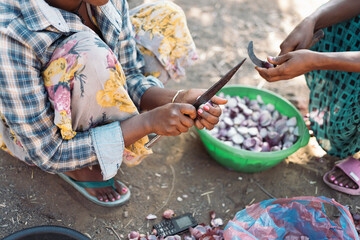 African women cooking in traditional clothing.