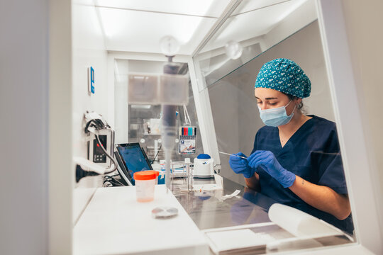 Female biologist with semen specimen in lab