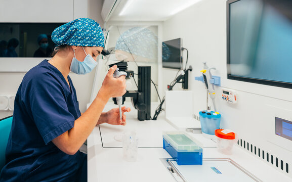 Female biologist performing IVF procedure
