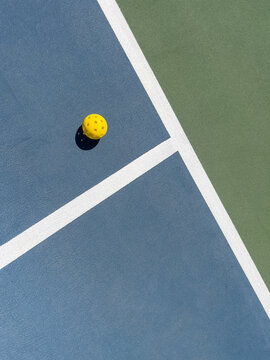 Pickleball court background texture with lone ball and lines 