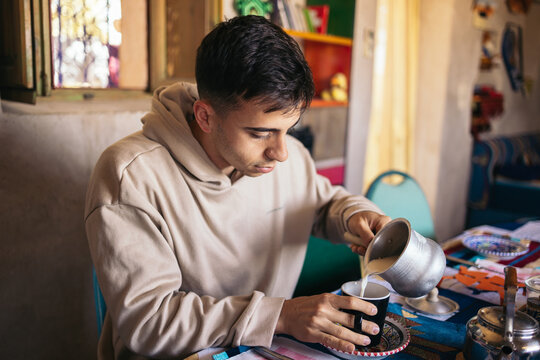 Young tourist man having breakfast in an arabic house