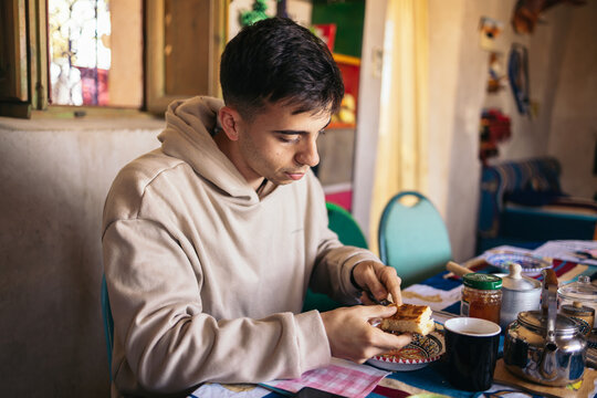 Young tourist man having breakfast in an arabic house