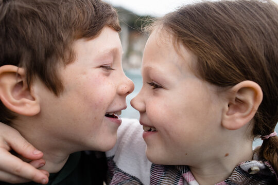 Freckled faces of brother and sister