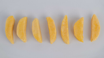 Healthy freeze dried fruits. Pieces of mango with freeze dry process isolated on white background.