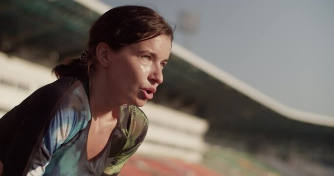 Sweaty tired sportswoman breathing heavily after training