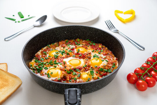 Ready Fried eggs with vegetables and bread, top view. Recipe and cooking process for Shakshuka and Menemen. Tasty breakfast
