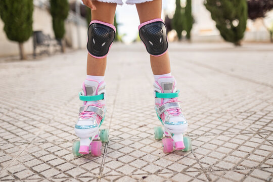 little girl on roller skates in the city