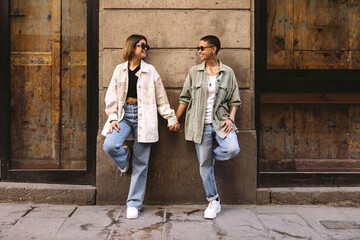 Happy lesbian couple standing on street