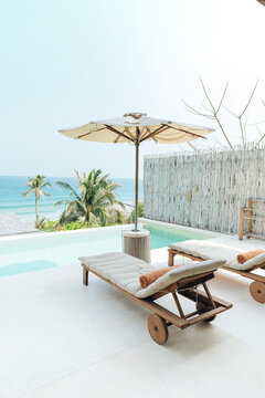 Fantastic overwater villa with sun beds chairs under umbrella,