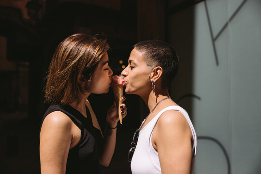 Loving diverse girlfriends eating ice cream - Powered by Adobe