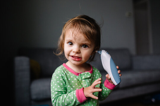 Toddler tries to take her own temperature